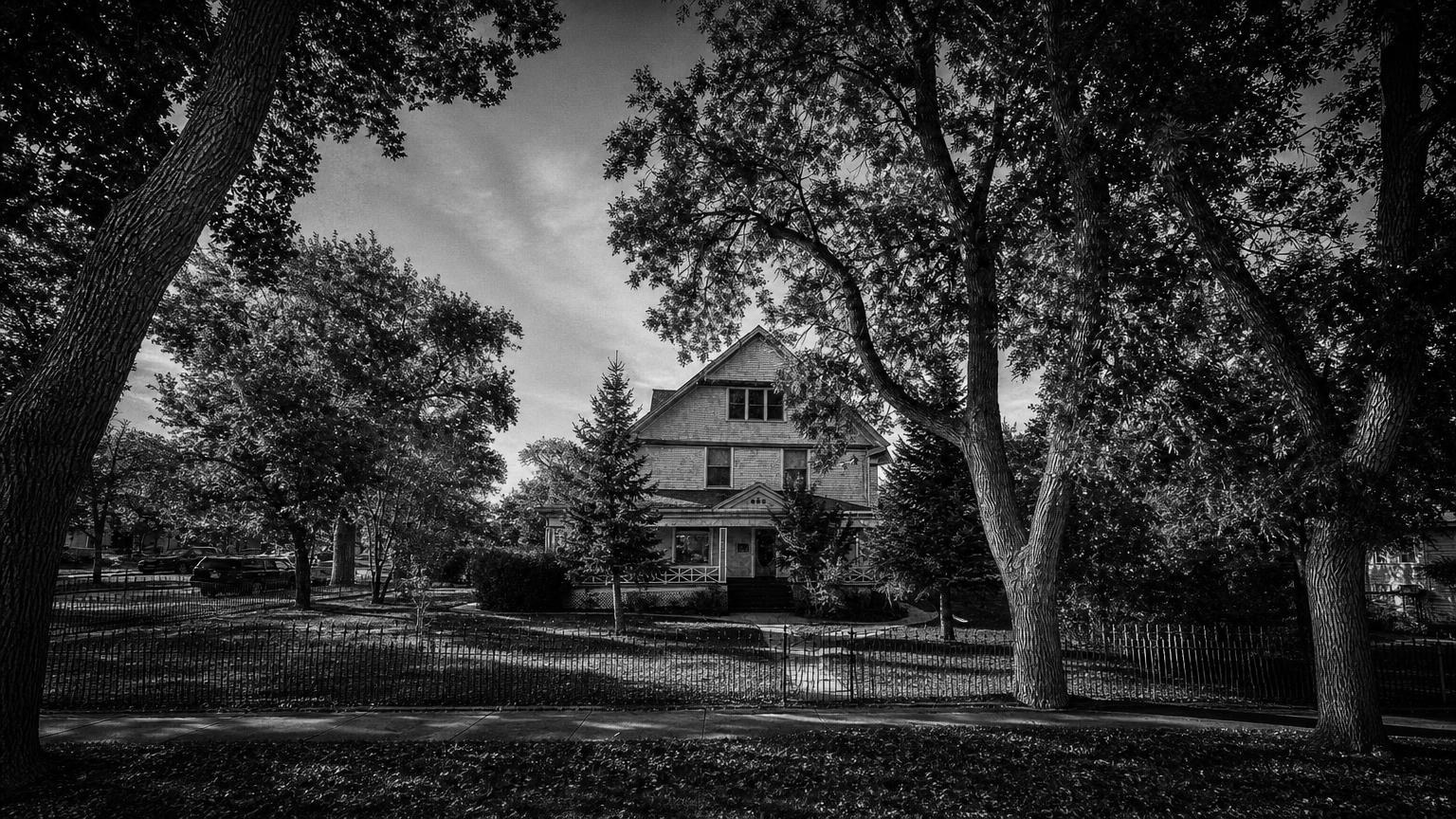 Monochrome editorial rendering of Morton Mansion's gabled exterior behind trees.