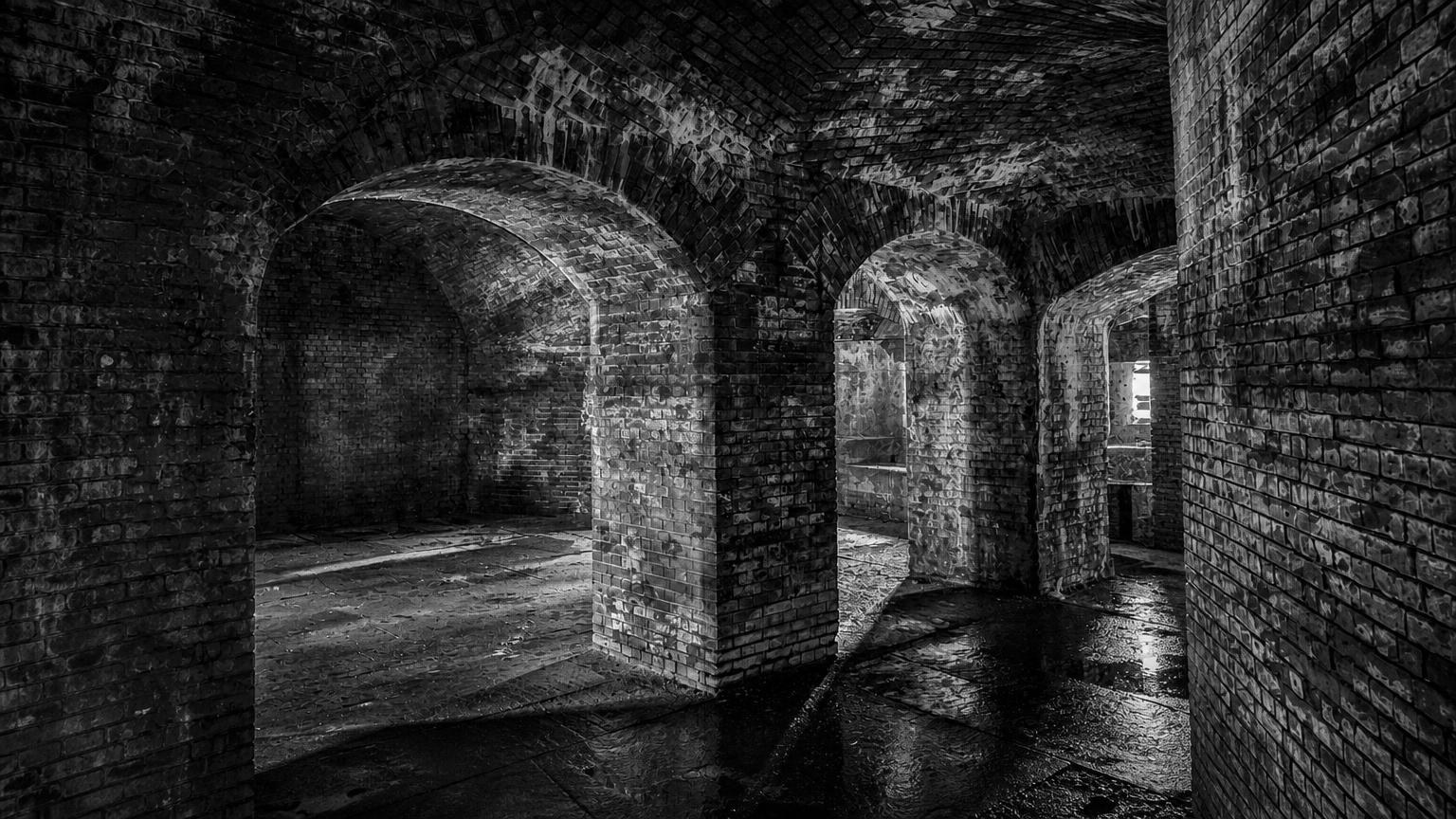 Monochrome editorial rendering of Fort Delaware's brick arches and interior passage.
