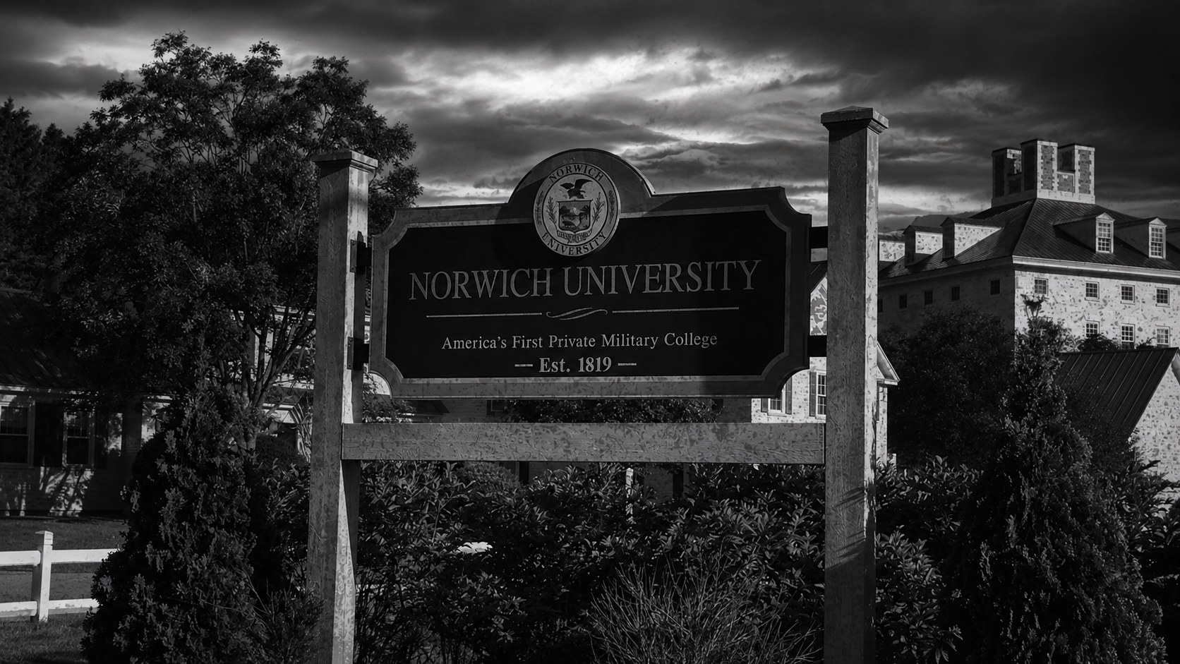 Monochrome editorial rendering of the Norwich University campus entrance.
