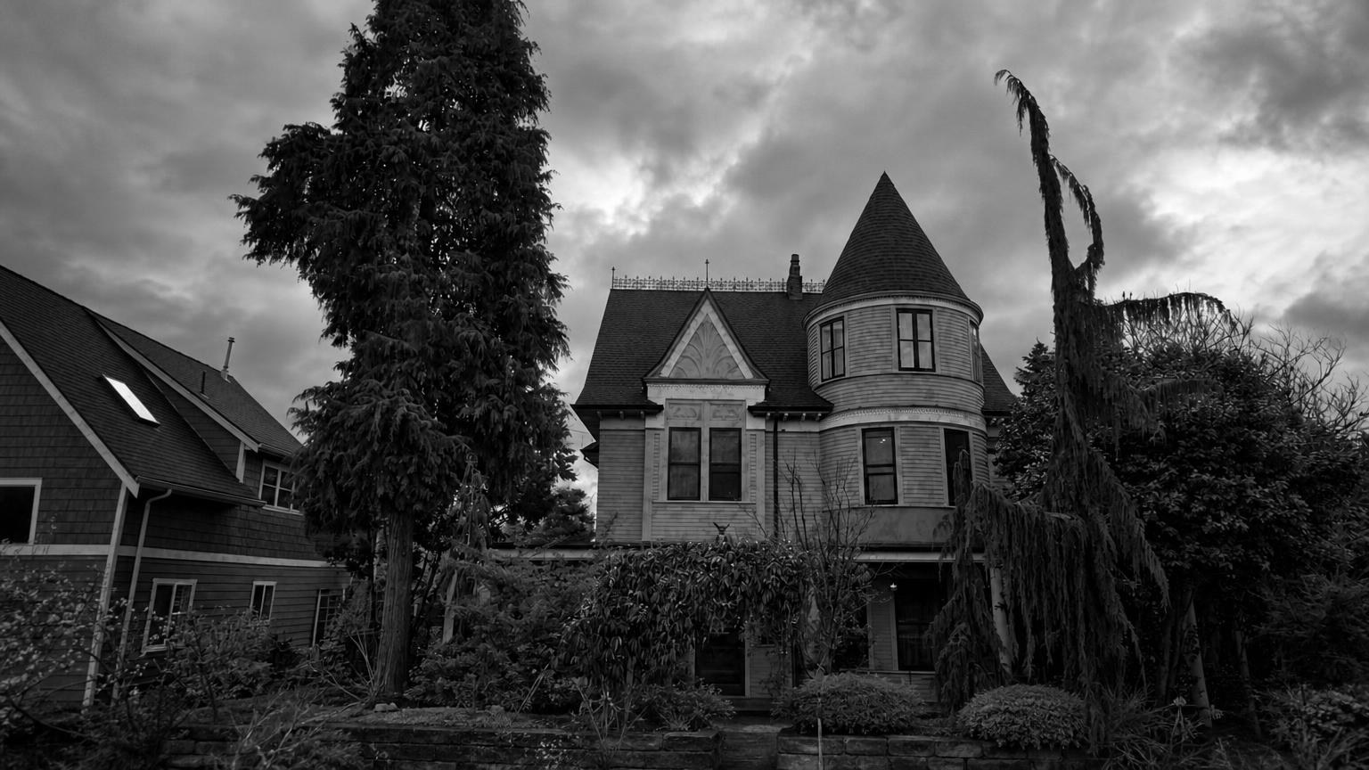 Monochrome editorial rendering of Georgetown Castle's gables and turret behind trees in Seattle.