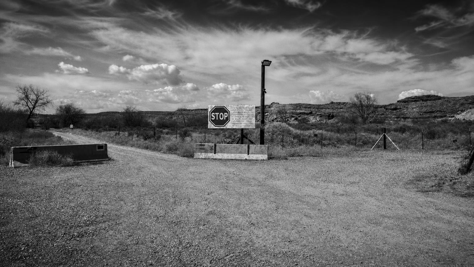 Monochrome editorial rendering of the restricted entrance to Skinwalker Ranch.