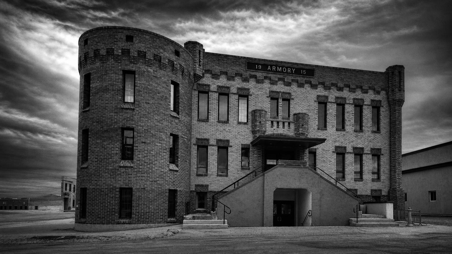 Monochrome editorial rendering of Williston's Old Armory with its round corner tower and exterior stairway.