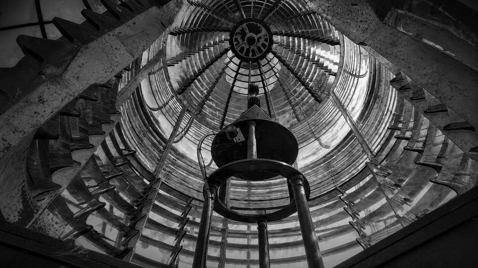 Monochrome editorial rendering of the lens inside Seguin Island Lighthouse.