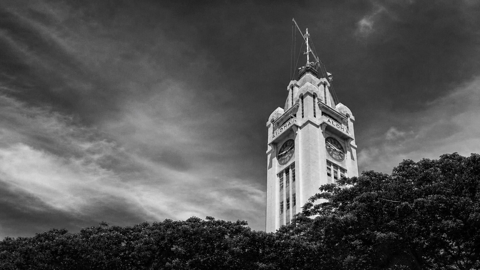 Monochrome editorial rendering of Aloha Tower rising above trees in Honolulu.