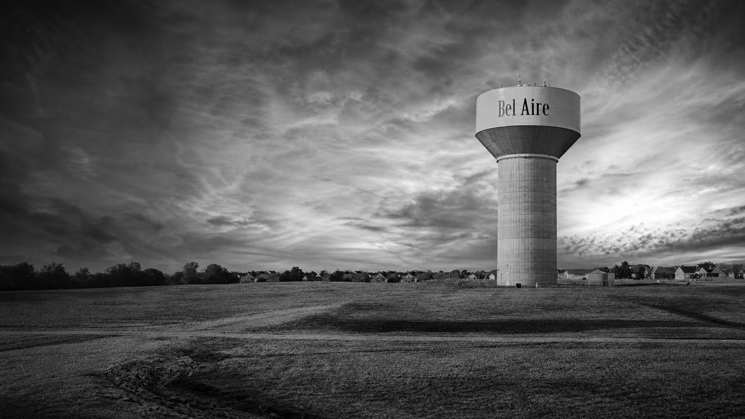 Monochrome editorial rendering of the Bel Aire water tower above an open field.