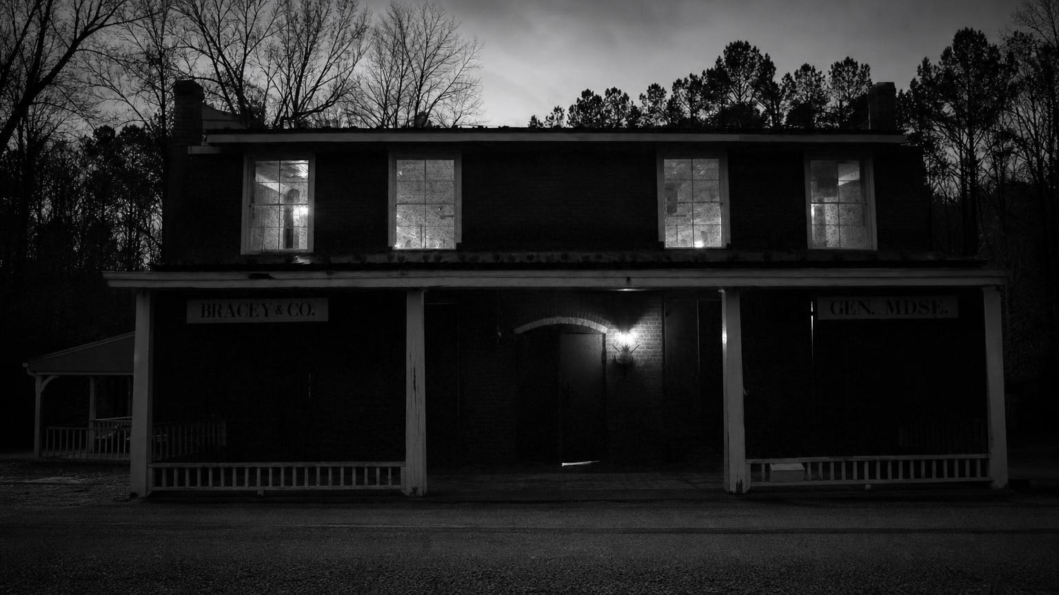 Monochrome editorial rendering of Bracey General Store's two-story frontage and covered porch.